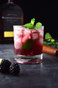 blackberry bourbon smash cocktail with pebble ice